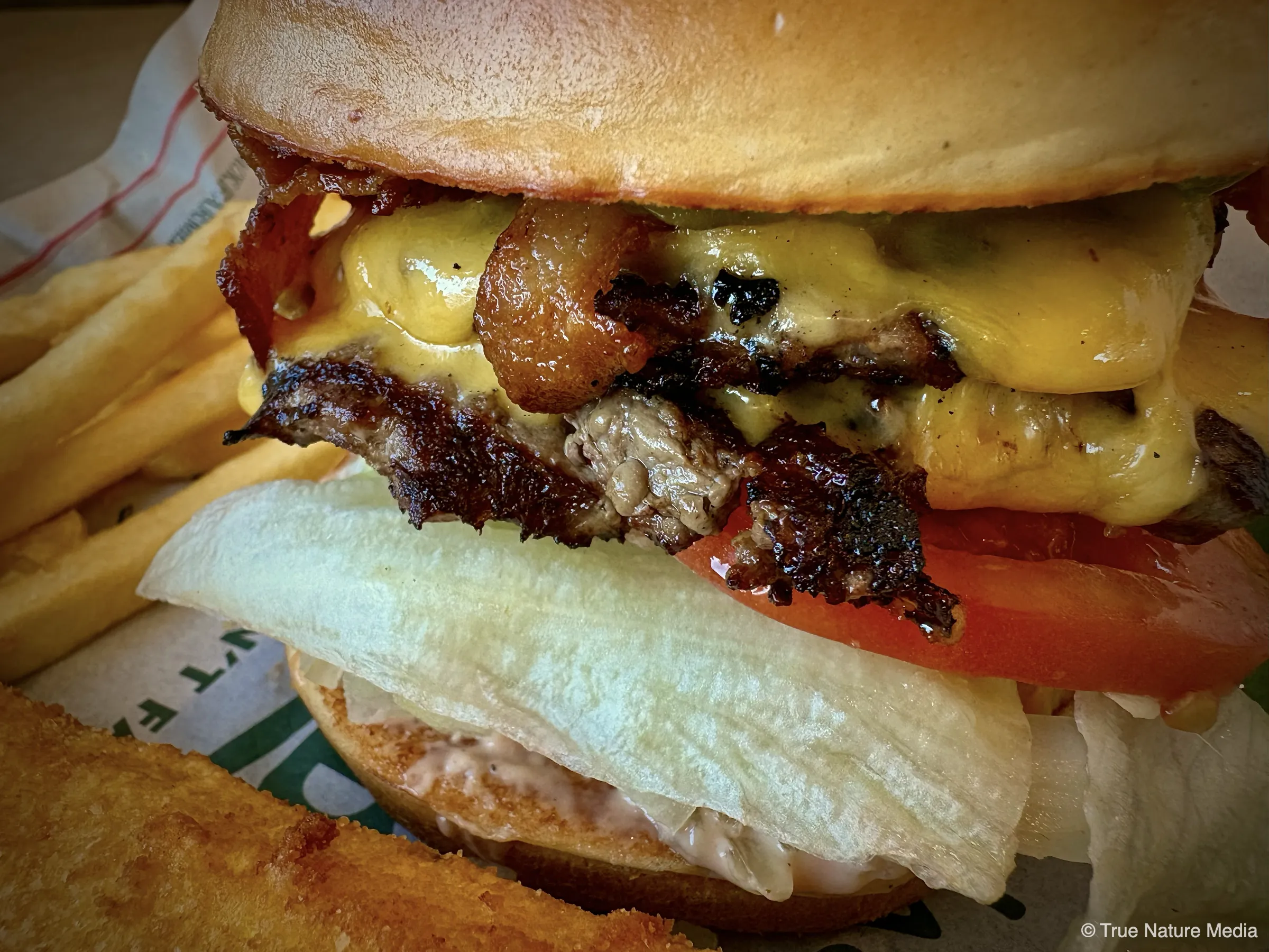 Farmer’s Burger at Farmer Boys Queen Creek with double patties, crispy bacon, guacamole, lettuce, tomato, and melted cheese